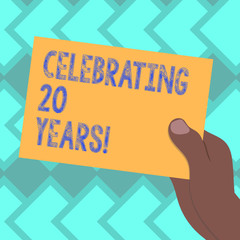 Text sign showing Celebrating 20 Years. Conceptual photo Commemorating a special day being 20 years together Drawn Hu analysis Hand Holding Presenting Blank Color Paper Cardboard photo