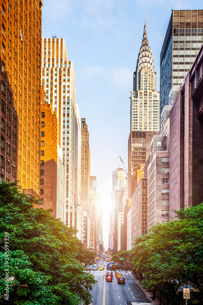 42nd street, Manhattan viewed from Tudor City Overpass with Chrysler Building in background in New York City during sunny summer daytime at sunset - obrazy, fototapety, plakaty 