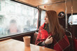 © bodnarphoto - Cute girl sits in a cozy cafe, covered with a blanket, looks thoughtfully in the window. Beautiful girl sits in a cozy coffee shop and warmly covered with a blanket. Cozy portrait.