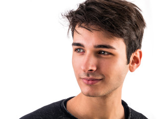 Close-up of handsome young man or teenager in studio, isolated on white background