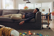 © Jacob Lund - Man sleeping on couch at home
