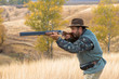© Mountains Hunter - Hunter with a hat and a gun in search of prey in the steppe