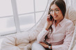 © Yakobchuk Olena - Charming asian girl talking by mobile phone