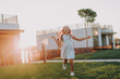 © Yakobchuk Olena - Joyful little girl catching the butterfly outdoors