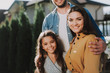 © Yakobchuk Olena - Happy parents are standing with their child