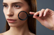 © Yakobchuk Olena - Beautiful girl demonstrating perfect skin through magnifying glass