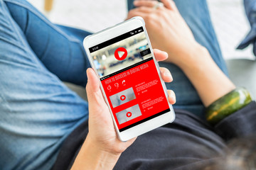 Aufkleber - Top view woman watching video online with advertising on mobile on sofa at home.viral influencer media concept.