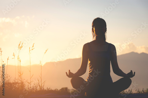 Cuadros en Lienzo silhouette fitness girl practicing yoga on mountain