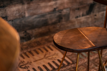 Rustic wood and bronze metal bar stools. Close up details. Coffee shop, home loft interior design, minimalism concept