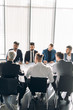 © alfa27 - Business Discussion Meeting Presentation Briefing with the participation of male stuff only. Formally dressed multiracial men, working as a team, working out new strategy of development