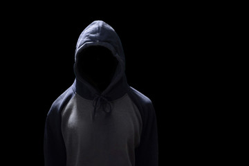 Poster - Hacker standing isolated on black background. Human anonymous in safety security computer technology concept. Anonymous