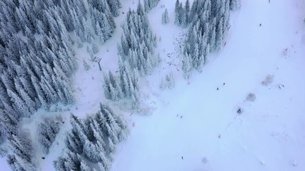 Wall Mural - Aerial view of the ski slope in the mountains where skiers ride.