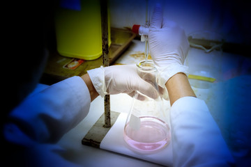 Wall Mural - chemist is testing chemical by titration technique in chemical laboratory