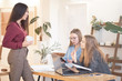 © yavdat - three girls while working in the office, a break for a cafe, gossip in the office