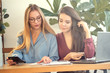 © yavdat - two young girls work in a beautiful green office. ecology and ergonomics in the office. comfortable environment to increase employee efficiency.