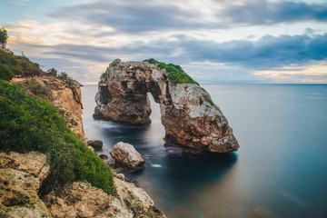 Wall Mural - Es Pontas Beautiful Natural Arch on Mallorca Island seen at sunrise