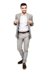 stylish young bearded guy in a gray suit posing on a white background