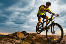 Cyclist Riding The Mountain Bike On Rocky Trail At Sunset. Extreme Sport And Enduro Biking Concept.