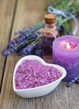 Fototapeta Lawenda - Heart-shaped bowl with sea salt and fresh lavender flowers on a old wooden table