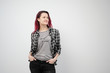 © spaskov - The girl in a plaid gray shirt on a white background with dyed red hair.