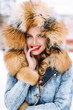 © irinaneva - beautiful blonde girl posing in winter fur coat in the snow