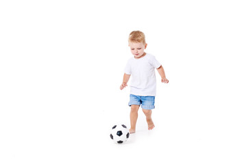 Little cute kid baby boy 3 years old, football fan in white t-shirt playing with soccer ball isolated on white background.  lifestyle concept. Copy space for text