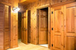 Interior of room with doors and wood paneling inside a beautiful wooden cabin
