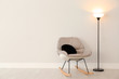 Modern floor lamp and rocking chair against light wall indoors. Space for text