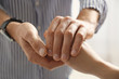 © New Africa - Man comforting woman on light background, closeup of hands. Help and support concept