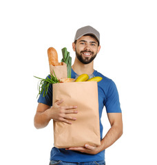 Canvas Print - Man holding paper bag with fresh products on white background. Food delivery service