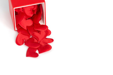 Red small hearts dropped out of a gift box on the white isolation background. St. Valentine’s Day card