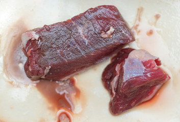 slices of raw meat on a white background