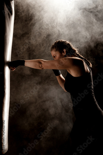 Принти на полотні kick fighter girl punching a boxing bag