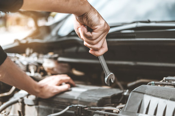 Wall Mural - Auto mechanic working in garage Technician Hands of car mechanic working in auto repair Service and Maintenance car check.