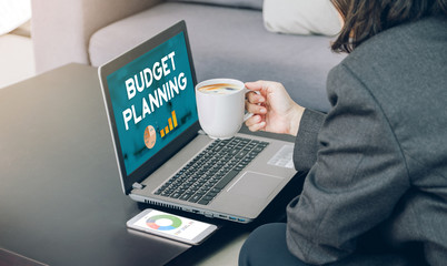 Aufkleber - businesswoman holding coffee cup and see budget planning report on laptop screen on office desk with marketing plan on mobile phone.