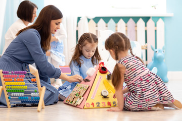 Kids play with educational toys in nursery