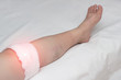 Medical compress on the knee joint in a woman, treatment of the knee with traditional medicine, close-up, inflammation