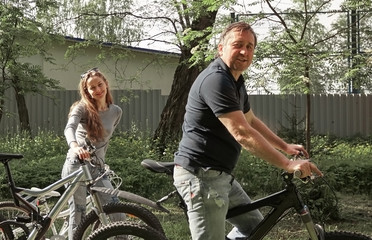 happy couple on a bike ride in the city Park