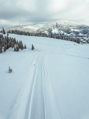 Wall Mural - Winter rural landscape wallpaper from a snow covered road and mountains