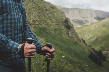 Wall Mural - Unrecognizable Traveler With Trekking Poles In Hands. Journey Outdoor