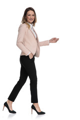 Poster - side view of businesswoman walking with hand in pocket