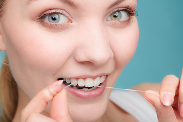 Wall Mural - Woman face smiling with dental floss.