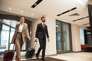 Couple on a business trip doing check-in at the hotel