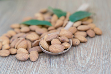 Almond nut on wood background.