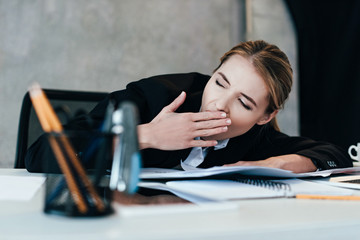 selective focus of gaping businesswoman at work-table with documents