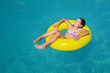 © SuperCoolPhotography - Real adorable girl relaxing in swimming pool