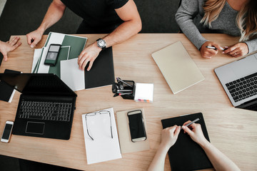 Co-working business people at one table a top view. Work for laptops on the table. Startup development