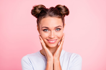 Poster - Close-up portrait of her she nice attractive adorable fascinating lovable cute winsome cheerful girl with buns touching cheeks isolated over pink pastel background