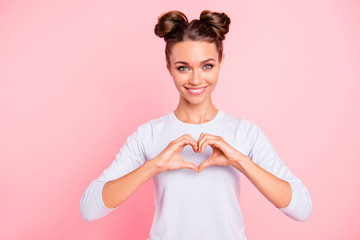 Wall Mural - Portrait of her she nice attractive lovely sweet fascinating winsome cheerful cheery girl showing heart isolated over pink pastel background