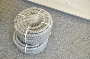 two rolls of corrugated pipe